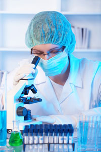 researcher looking in microscope