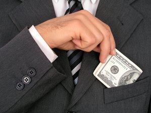 businessman putting money in his jacket pocket