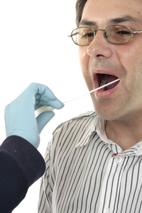 man having the inside of his mouth swabbed for dna testing