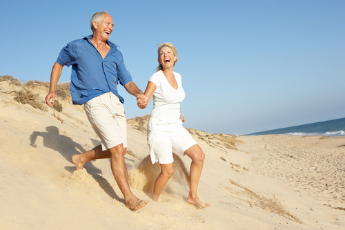 happy people running on the beach